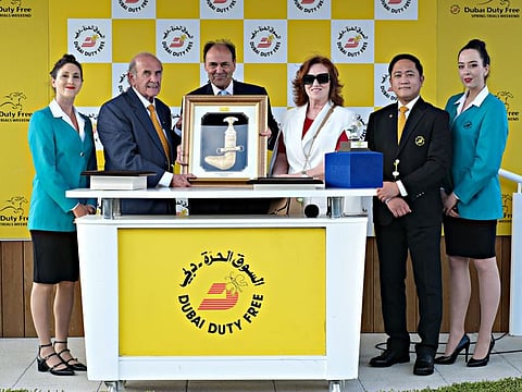 Godolphin Stud Director, Liam O'Rourke, receives the trophy for the Group 3 Dubai Duty Free Stakes from Colm McLoughlin and Sinead El Sibai at Newbury on Saturday.