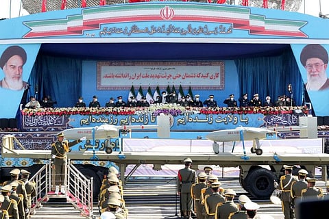Iranian President Ebrahim Raisi and military commanders watch as military equipment passes by during a ceremony of the National Army Day parade in Tehran on April 18, 2022.