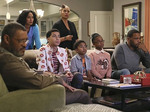 Laurence Fishburne, from left, Tracee Ellis Ross, Marcus Scribner, Jennifer Lewis, standing center, Miles Brown, Marsai Martin and Anthony Anderson appear in an episode of "Black-ish".