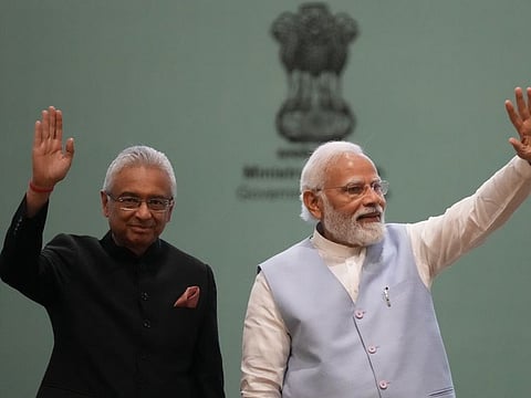 Indian Prime Minister Narendra Modi, and Mauritius Prime Minister Pravind Kumar Jugnauth wave during Global Ayush Investment and Innovation Summit 2022 (GAIIS) in Gandhinagar, India, Wednesday, April 20, 2022.