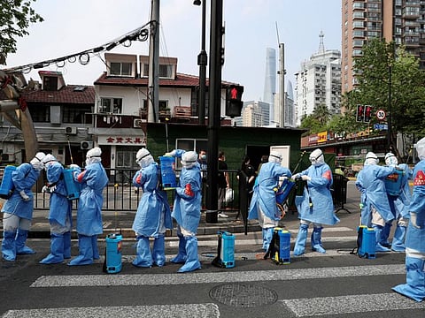 Workers prepare to disinfect a residential compound in Huangpu district, following the COVID-19 outbreak in Shanghai, on April 20, 2022.