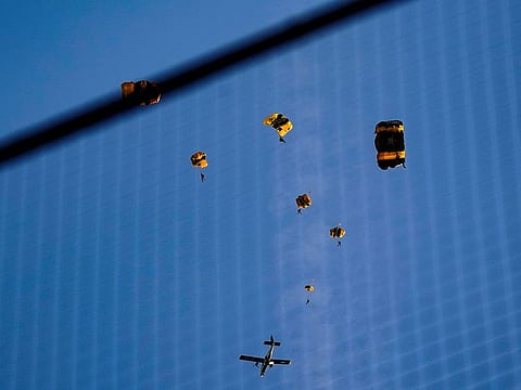The US Army Parachute Team the Golden Knights jump out of their aircraft before a baseball game between the Washington Nationals and the Arizona Diamondbacks at Nationals Park, Wednesday, April 20, 2022, in Washington. The US Capitol was briefly evacuated after police said they were tracking an aircraft “that poses a probable threat,” but the plane turned out to be the military aircraft with people parachuting out of it for a demonstration at the Nationals game, officials said.