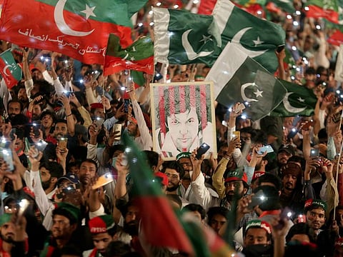 Supporters of former Pakistani Prime Minister Imran Khan listen the speech of their leader in Lahore on April 21,2022.