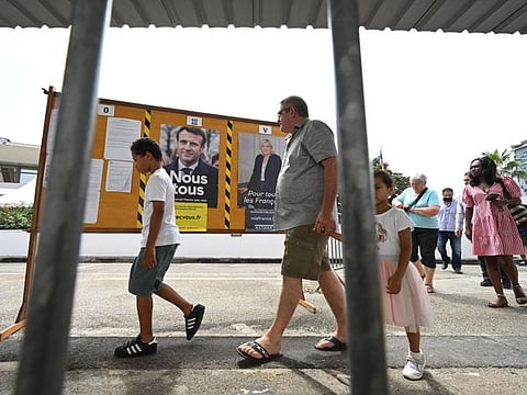 French nationals arrive to cast their ballots as they vote in the second round of French presidential elections, at a polling station in the Consulate General of France in Abidjan on April 24, 2022.