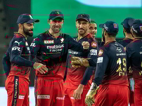 Royal Challengers Bangalore players celebrate the wicket of Trent Boult of Rajasthan Royals on April 26, 2022. The RCB campaign is faltering, but a revival can preserve their chances of making the last four this season.
