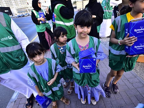 Volunteers distributing iftar as part of the initiative by Dubai police and other partners to provide mea0ls everyday in Ramadan for drivers in Dubai.