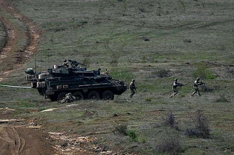 US Army armoured vehicle take part in a NATO joint military tactical training exercise with Bulgaria's army at Novo Selo military ground on April 21, 2022.
