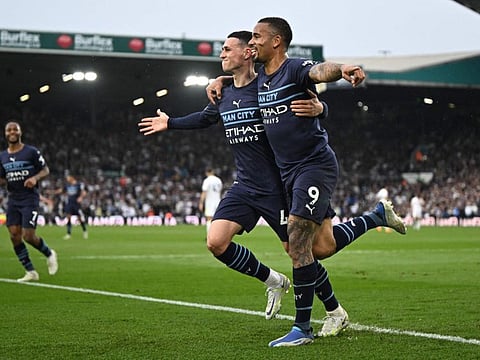 Manchester City's Brazilian striker Gabriel Jesus (right) celebrates with Manchester City's English midfielder Phil Foden after scoring their third goal during the English Premier League football match against Leeds United at Elland Road in Leeds, northern England.