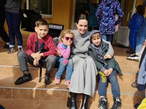 us actor and UNHCR Special Envoy Angelina Jolie poses for a picture with children, as Russia's attack on Ukraine continues, in Lviv, Ukraine April 30, 2022.