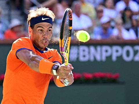 Rafael Nadal hits a shot during the men’s final against Taylor Fritz of USA at the BNP Paribas Open at Indian Wells. The Spaniard suffered a stress fracture to his ribs during the event.