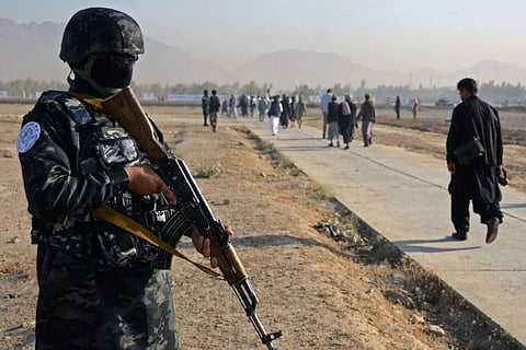 A Taliban fighter stands guard as devotees arrive to offer Eid Al Fitr prayers. While Afghanistan is a deeply conservative, patriarchal country, it is not uncommon for women to drive in larger cities - particularly Herat in the northwest, which has long been considered liberal by Afghan standards.