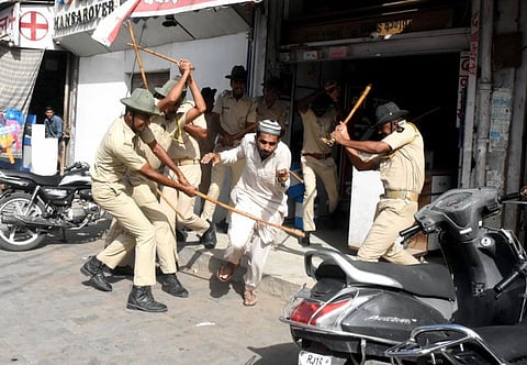 Police baton charge protesters after clashes broke out between two communities, in Jodhpur on Tuesday.