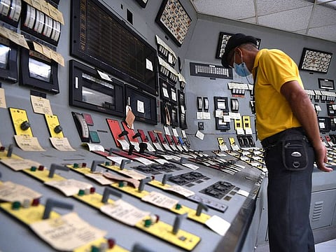 An employee checking switches inside the control room at the unussed Bataan Nuclear Power Plant in the Philippines.