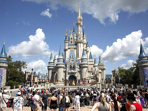 A file photo of visitors watching a performance at the Cinderella Castle at the Walt Disney Co. Magic Kingdom park in Orlando.
