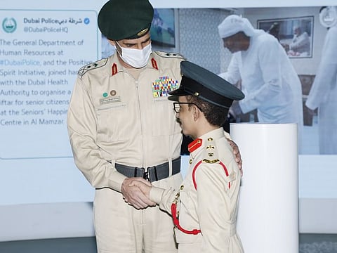 Dubai Police Chief Lt Gen Abdullah Khalifa Al Marri greets student of determination Khalid Al Amiri at the Dubai Police Headquarters.