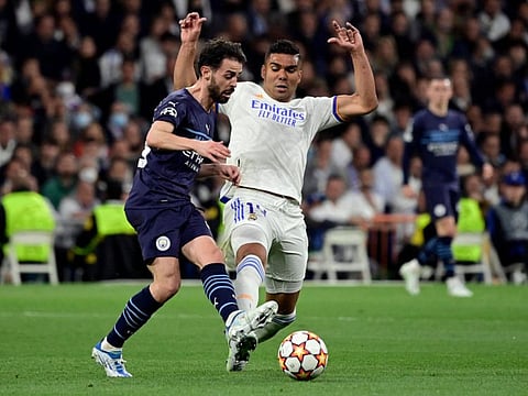 Manchester City's Portuguese midfielder Bernardo Silva (left) vies with Real Madrid's Brazilian midfielder Casemiro during the UEFA Champions League semi-final second leg at the Santiago Bernabeu stadium in Madrid.