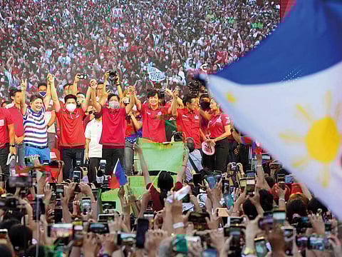 Presidential hopeful, former senator Ferdinand "Bongbong" Marcos Jr., centre, gestures as he greets the crowd during a campaign rally in Quezon City, Philippines on April 13, 2022.