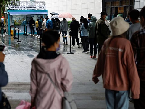 People line up to get tested at a mobile nucleic acid testing site outside a shopping mall, amid the coronavirus disease (COVID-19) outbreak in Beijing, China May 6, 2022.