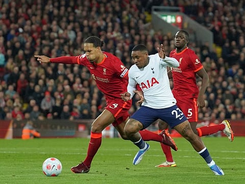 Liverpool's Virgil van Dijk (left) fights for the ball with Tottenham's Steven Bergwijn during the English Premier League match at Anfield stadium in Liverpool, England.