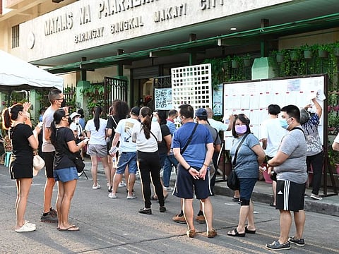 A scene outside a polling precinct in the Philippines on Monday. More than 65.7 million registered voters started queueing up from as early as 6am for the high-stakes vote to pick a successor to President Rodrigo Duterte.