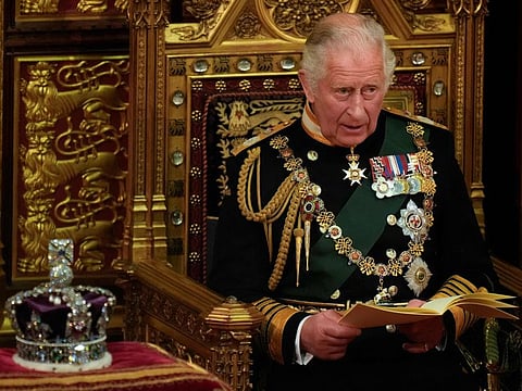 Britain's Prince Charles, Prince of Wales, reads the Queen's Speech as he sits by the Imperial State Crown, in the House of Lords chamber, during the State Opening of Parliament, at the Houses of Parliament, in London, on May 10, 2022.