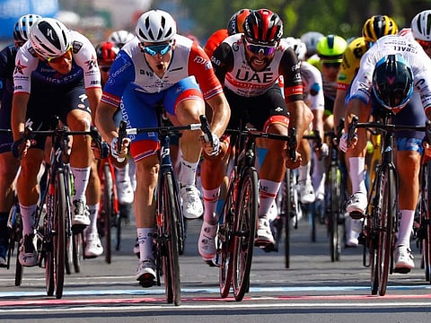 Team Groupama-FDJ's French rider Arnaud Demare (second from left) crosses the finish line to win the 174-km fourth stage between Catania and Messina in Sicily of the Giro d'Italia 2022 cycling race on Wednesday.