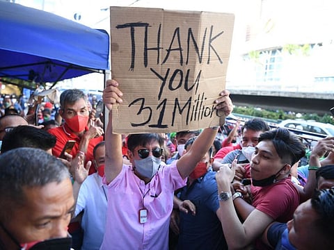 Presidential candidate Ferdinand Marcos Jr is mobbed by his supporters as he arrives at the campaign headquarters in Manila on May 11, 2022.