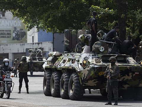 Sri Lankan army officers on patrol during a curfew in Colombo on May 11, 2022.