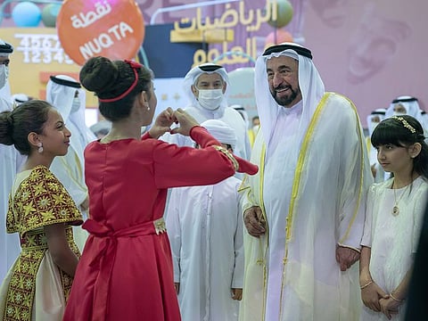 His Highness Dr Sheikh Sultan bin Muhammad Al Qasimi greeted by children during the opening of the festival