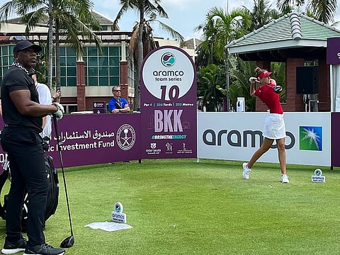 Dubai-based Chiara Noja teeing off on Hole 10 at Thai Country Club as Victor Green (left), a NFL legend and her amateur playing partner, looks on.