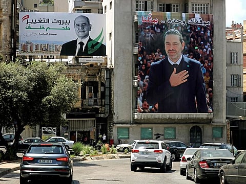 A Lebanese parliamentary elections campaign billboard for candidate Melhem Khalaf (left) hangs on a building next to one of former PM Saad Hariri, in Beirut. Hariri’s January 2022 decision to boycott the upcoming elections has shifted focus back to Lebanon’s Sunnis, away from Maronite Christians and their politics.