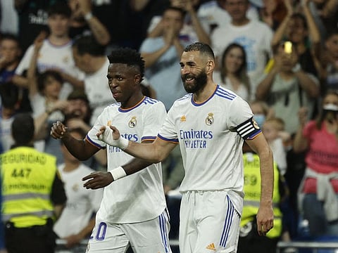 Real Madrid's Vinicius Junior celebrates scoring their fifth goal against Levante with Karim Benzema.