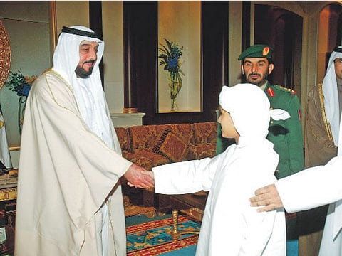 Popular leader: Shaikh Khalifa receives Eid Al Adha greetings from a boy and his father at the Guest Palace in Abu Dhabi in December 2006.