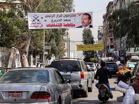 A banner bearing the picture of former Lebanese premier Saad Hariri and a slogan in Arabic which reads "commited to PM Saad Hariri's decision to boycott the elections", hangs on a street in the Tariq Al Jdideh neighbourhood of the capital Beirut.