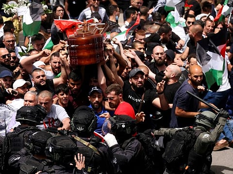 Family and friends carry the coffin of Al Jazeera reporter Shireen Abu Aqleh, who was killed during an Israeli raid in Jenin, as clashes erupted with Israeli security forces, during her funeral in Jerusalem, on May 13, 2022.