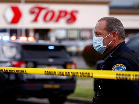 Police officers secure the scene after a shooting at TOPS supermarket in Buffalo, New York, May 14, 2022.