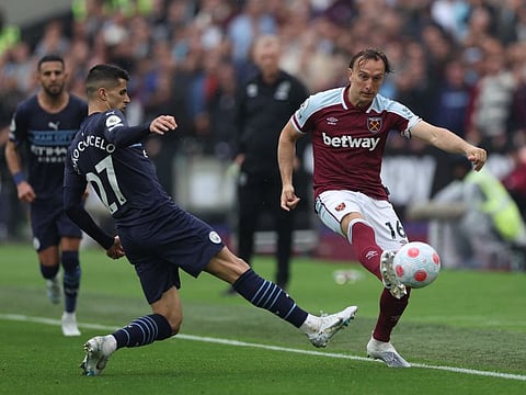 Manchester City's Joao Cancelo in action with West Ham United's Mark Noble.