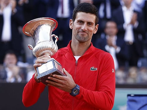 Serbia's Novak Djokovic celebrates with the trophy after winning the final against Greece's Stefanos Tsitsipas.