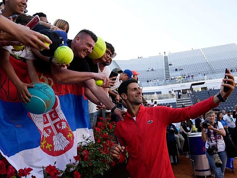 Serbia's Novak Djokovic celebrates with fans after winning his final match against Greece's Stefanos Tsitsipas at the Italian Open tennis tournament, in Rome.