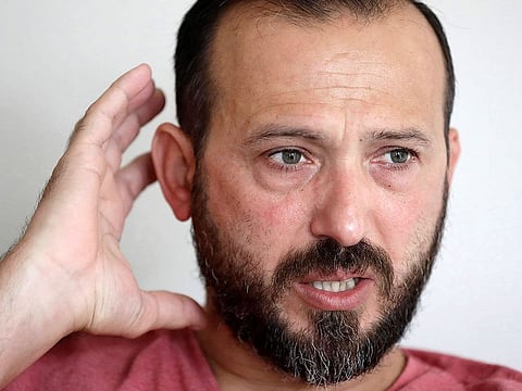 Al Noor mosque shooting survivor Temel Atacocugu reacts during an interview at his home, Feb. 25, 2020, in Christchurch, New Zealand.