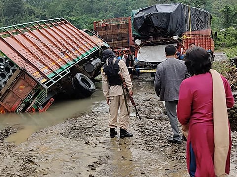 People inspect the area of a landslide after heavy rainfall in Dima Hasao district, in the northeastern Indian state of Assam, on May 16, 2022.