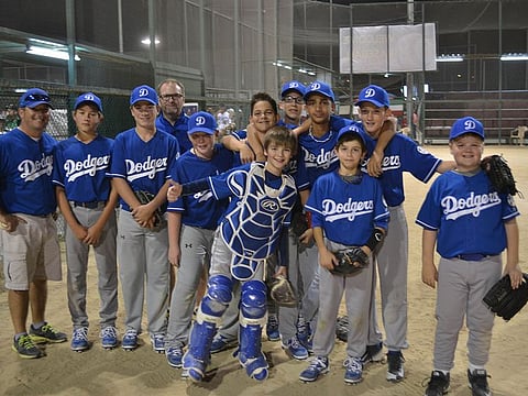 The Dubai Little League team on an away trip to Kuwait in 2016 with Dubai Little League President Roger Duthie (back row).