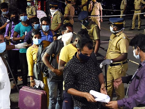 Migrants being screened as they arrive at Aluva station, Kerala.