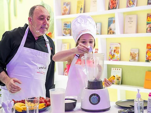 celebrity Arab chef Nidal Albrihi with a young cooking enthusiast at the ongoing 13th Sharjah Children’s Reading Festival (SCRF) at Expo Centre Sharjah.