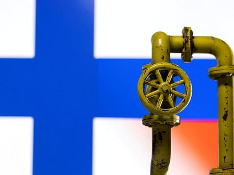 A model of the natural gas pipeline is seen in front of displayed Finnish and Russian flag colours in this illustration taken on April 26, 2022.