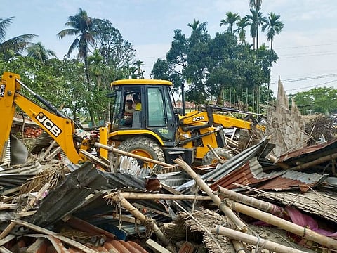 A bulldozer demolishes the house of Imran Ali and Mujibur Rahman, relatives of Safiqul Islam who was allegedly tortured to death in police custody. The relatives were blamed for taking part in burning Batadrava Police station.