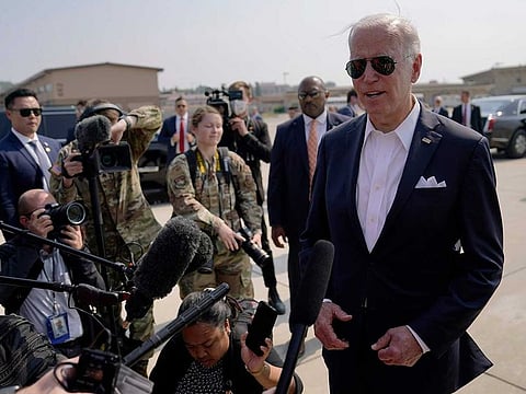 US President Joe Biden, right, speaks before boarding Air Force One for a trip to Japan at Osan Air Base, Sunday, May 22, 2022, in Pyeongtaek, South Korea.