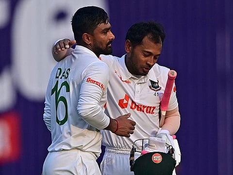 Bangladesh's Mushfiqur Rahim (right) embraces his teammate Liton Das at the end of the first day play against Sri Lanka