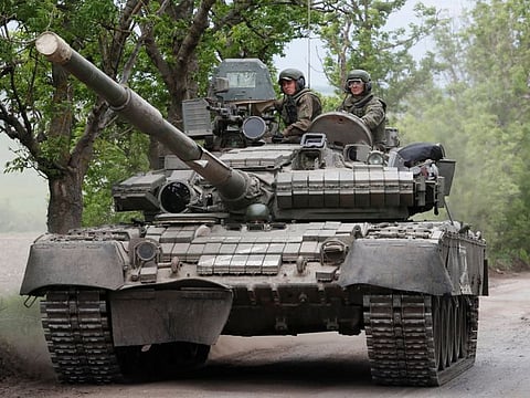 Service members of pro-Russian troops drive a tank during Ukraine-Russia conflict in the Donetsk Region, Ukraine May 22, 2022.