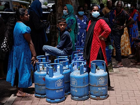 People wait in line to buy domestic gas tanks near a distributor, amid the country's economic crisis, in Colombo, Sri Lanka, May 23, 2022.